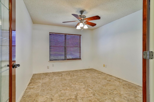 empty room featuring a textured ceiling and ceiling fan