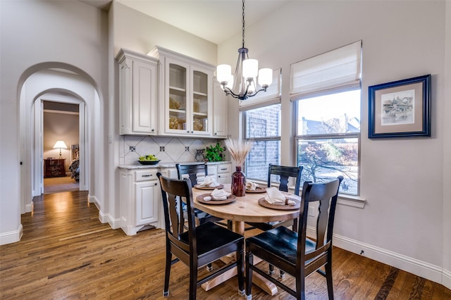 dining room with an inviting chandelier and dark hardwood / wood-style floors