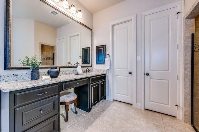 bathroom featuring vanity, a shower, and tile patterned floors