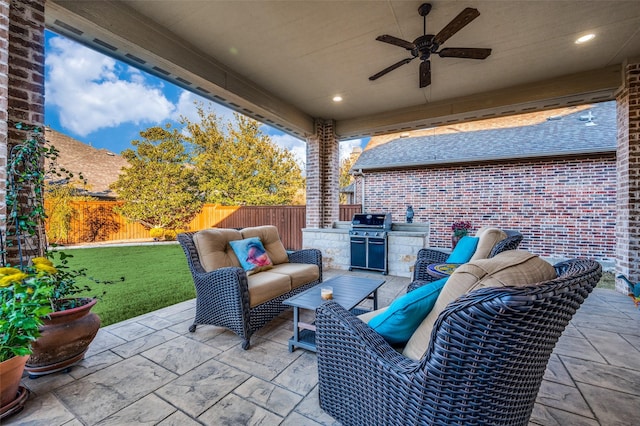 view of patio / terrace featuring exterior kitchen, an outdoor living space, and ceiling fan