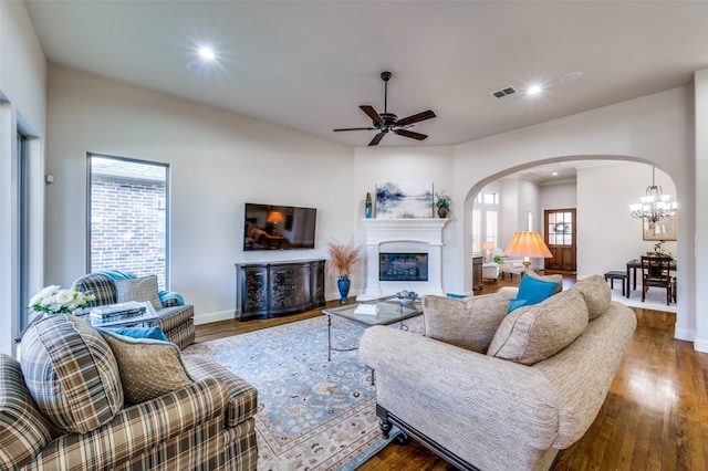 living room with ceiling fan, dark hardwood / wood-style flooring, and a wealth of natural light