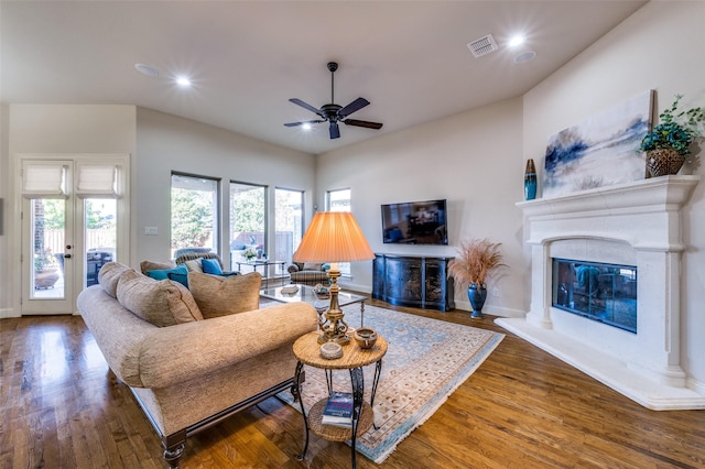 living room featuring dark hardwood / wood-style floors and ceiling fan