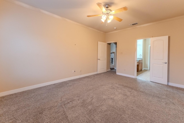 carpeted spare room with ornamental molding and ceiling fan