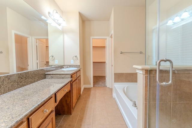 bathroom with tile patterned floors, independent shower and bath, and vanity