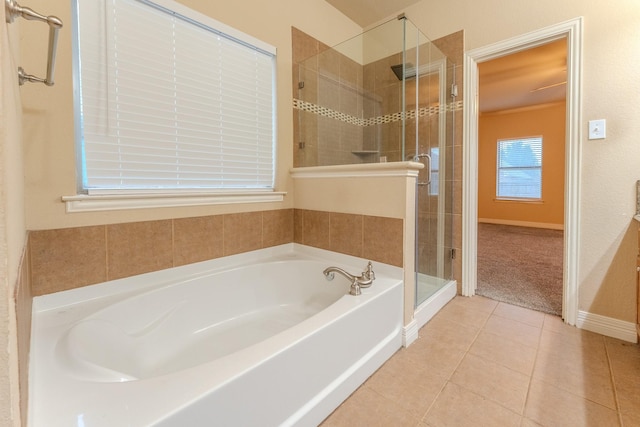 bathroom featuring tile patterned flooring and separate shower and tub