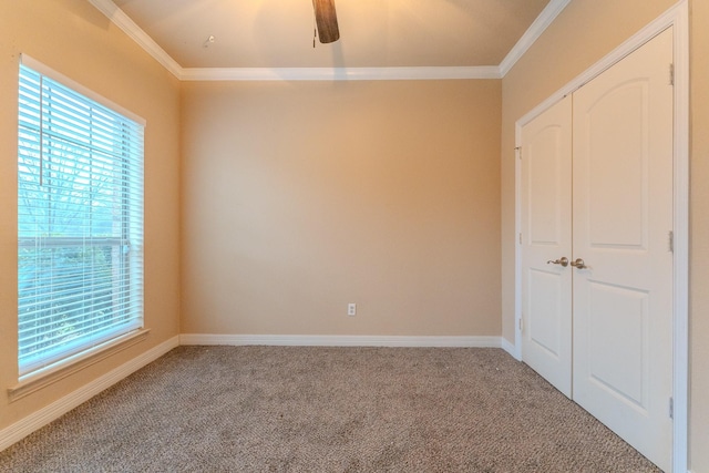 unfurnished bedroom featuring ornamental molding, carpet floors, and multiple windows