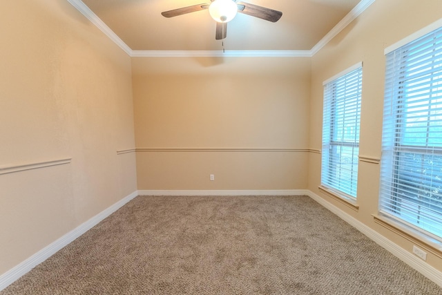 empty room with crown molding, ceiling fan, and carpet flooring