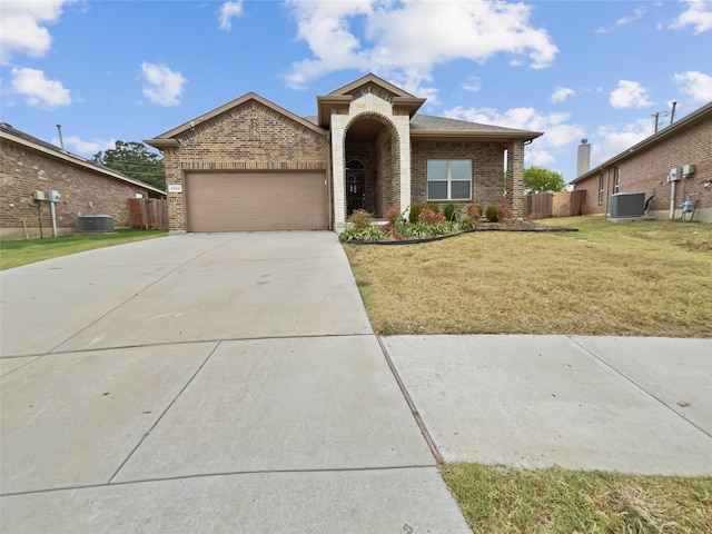 view of front of home with a garage, central AC unit, and a front lawn