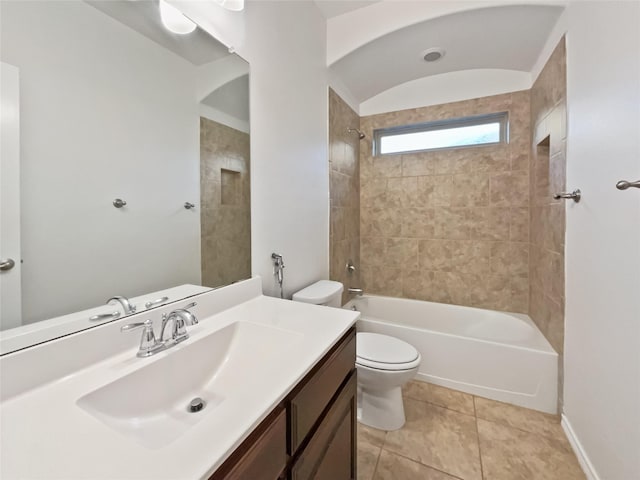 full bathroom featuring tiled shower / bath, vanity, toilet, and tile patterned floors