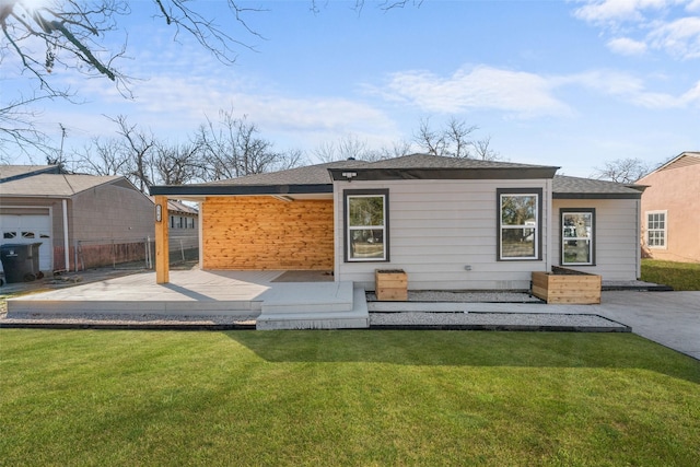 rear view of house with a lawn