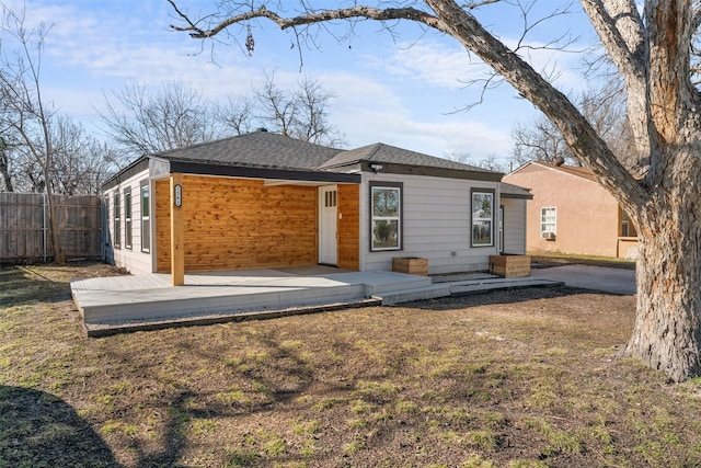 back of property with a patio and a yard