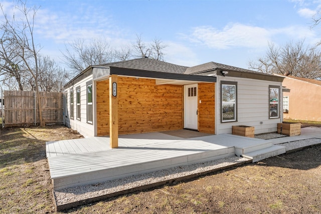 back of property with a wooden deck