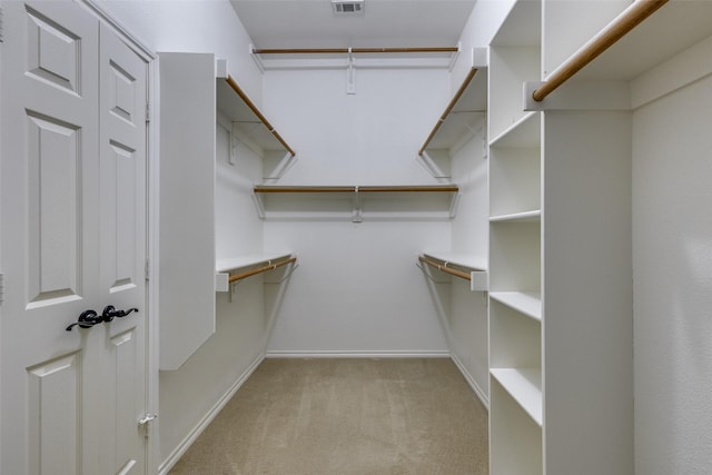 spacious closet featuring light carpet