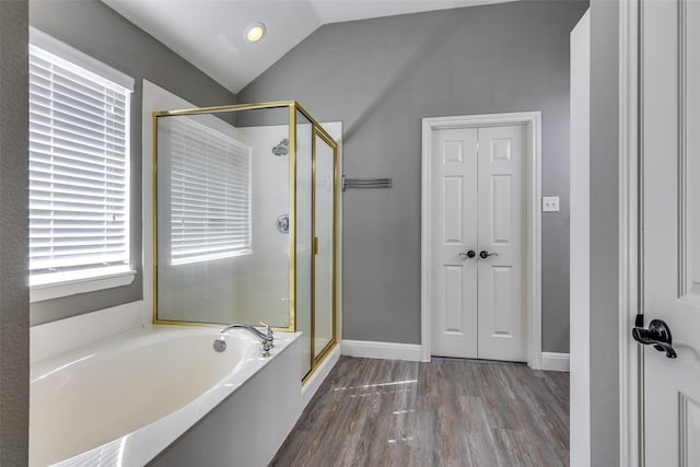 bathroom featuring lofted ceiling, separate shower and tub, and hardwood / wood-style floors