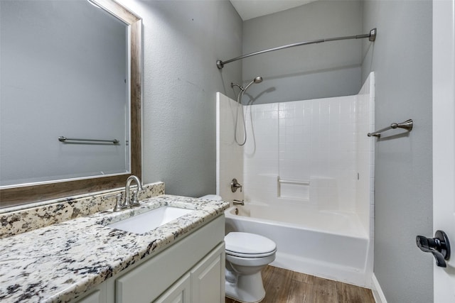 full bathroom with bathing tub / shower combination, hardwood / wood-style floors, vanity, and toilet