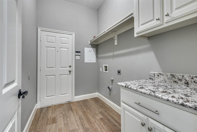 laundry area featuring hookup for a washing machine, electric dryer hookup, cabinets, and light wood-type flooring