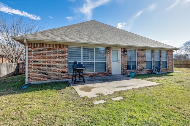 back of house featuring a patio area and a lawn