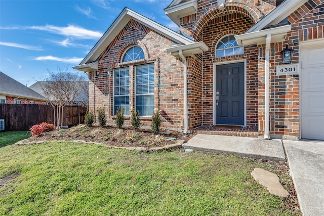 entrance to property with a lawn