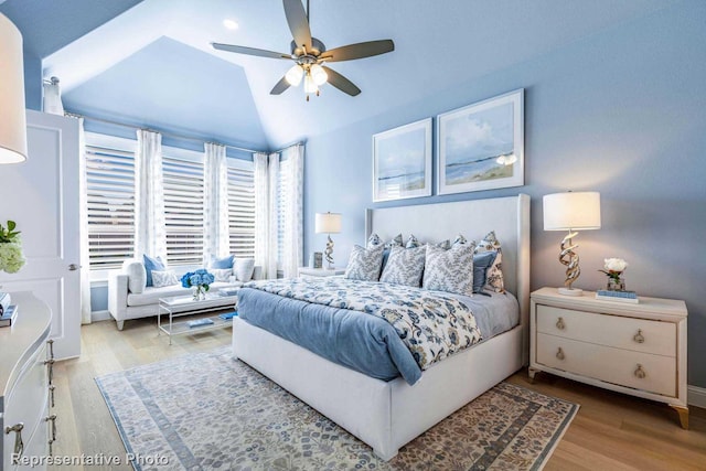 bedroom with ceiling fan, lofted ceiling, and wood-type flooring