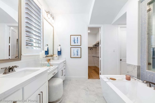 bathroom featuring vanity and a bath