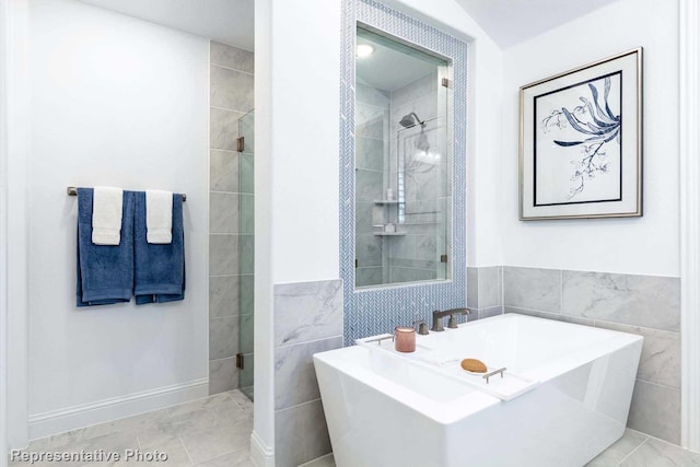 bathroom with shower with separate bathtub, tile walls, and tile patterned floors