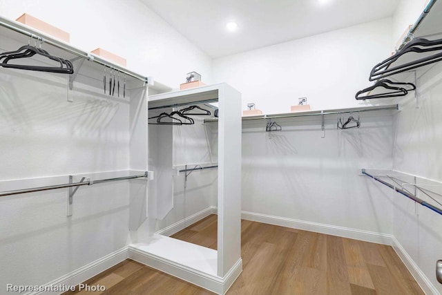 walk in closet with wood-type flooring