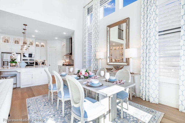 dining space featuring sink and light hardwood / wood-style flooring