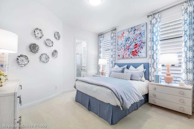 carpeted bedroom featuring connected bathroom