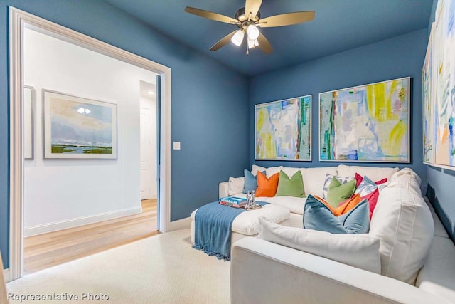 living room featuring ceiling fan and hardwood / wood-style floors