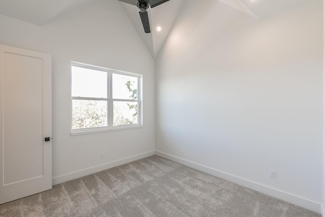 carpeted spare room featuring lofted ceiling