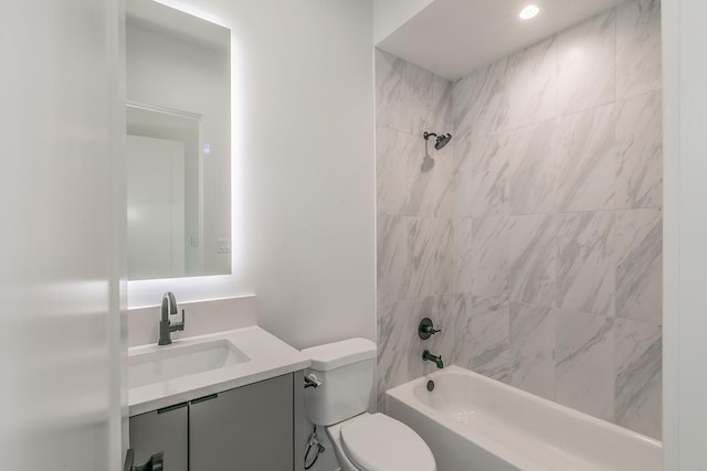 full bathroom with tiled shower / bath combo, vanity, and toilet