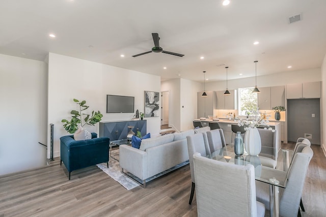 dining area with ceiling fan and light hardwood / wood-style flooring