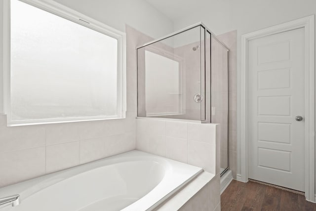 bathroom featuring wood-type flooring and independent shower and bath