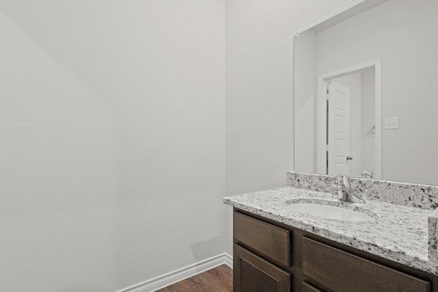 bathroom with hardwood / wood-style flooring and vanity