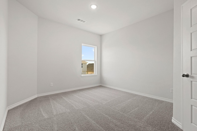 unfurnished room featuring visible vents, baseboards, and carpet flooring