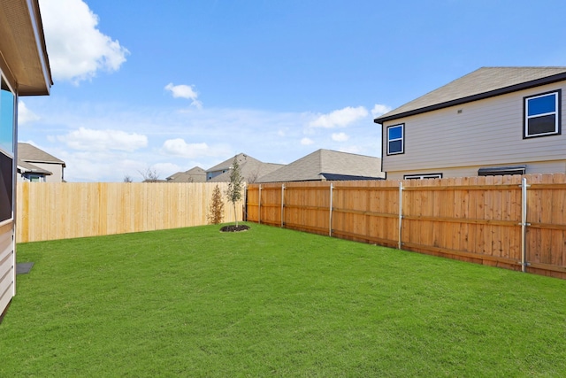 view of yard with a fenced backyard