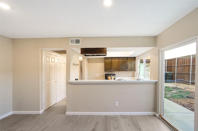 2658 Via Valencia, Carrollton, TX 75006 - kitchen featuring light wood finished floors, baseboards, and light countertops