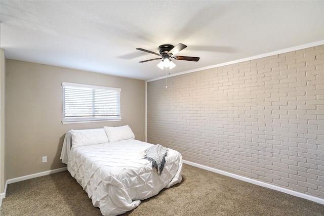 carpeted bedroom featuring ceiling fan, brick wall, and a textured ceiling