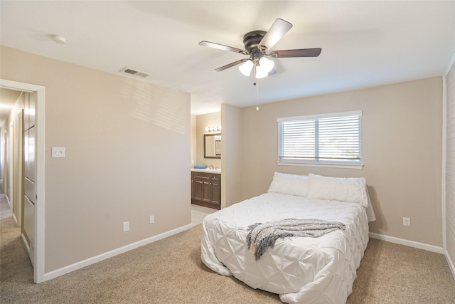 carpeted bedroom featuring ceiling fan and ensuite bathroom