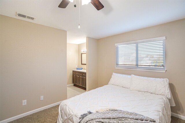 carpeted bedroom featuring connected bathroom and ceiling fan