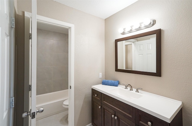 full bathroom with vanity, toilet, and tiled shower / bath combo