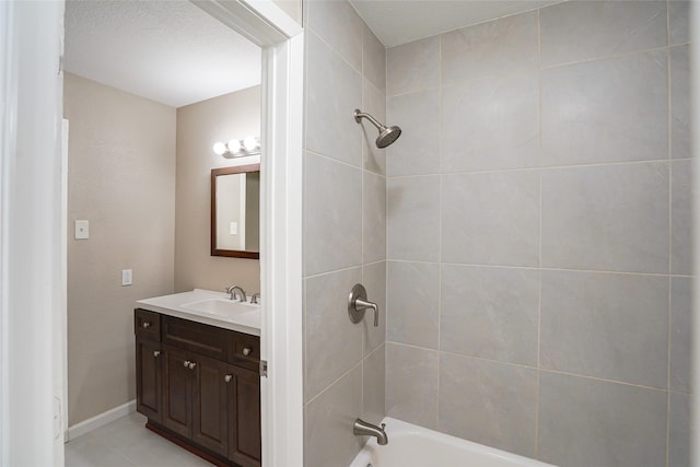 bathroom with tiled shower / bath and vanity