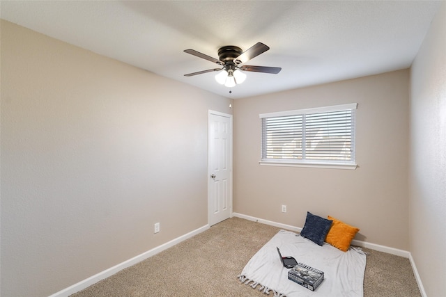 interior space featuring light carpet and ceiling fan