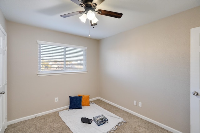 carpeted empty room featuring ceiling fan