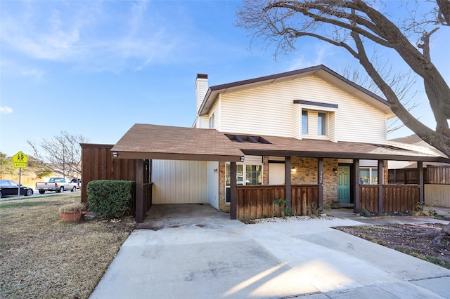 2658 Via Valencia, Carrollton, TX 75006 - view of front facade featuring a chimney, concrete driveway, roof with shingles, and covered porch