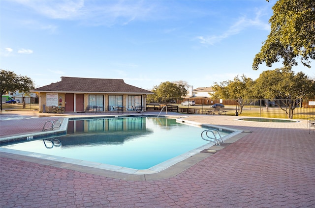 view of pool featuring a community hot tub and a patio