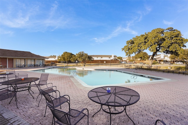 view of swimming pool with a patio area