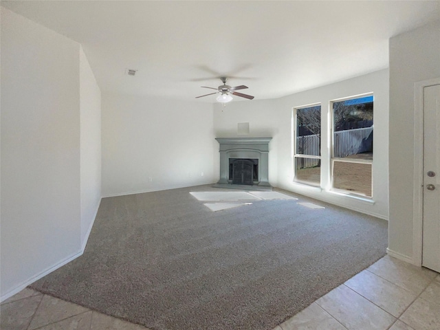 unfurnished living room featuring light colored carpet and ceiling fan