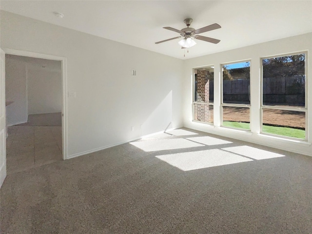 unfurnished room featuring ceiling fan and carpet