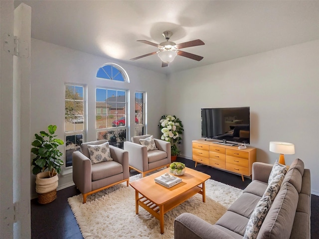 living room featuring ceiling fan and dark hardwood / wood-style flooring